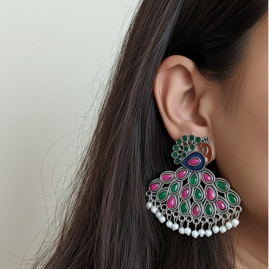 Magnificent kundan peacock jhumkas with ruby and emerald accents and lustrous pearl drops