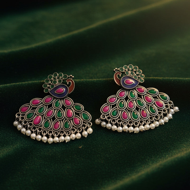 Magnificent kundan peacock jhumkas with ruby and emerald accents and lustrous pearl drops